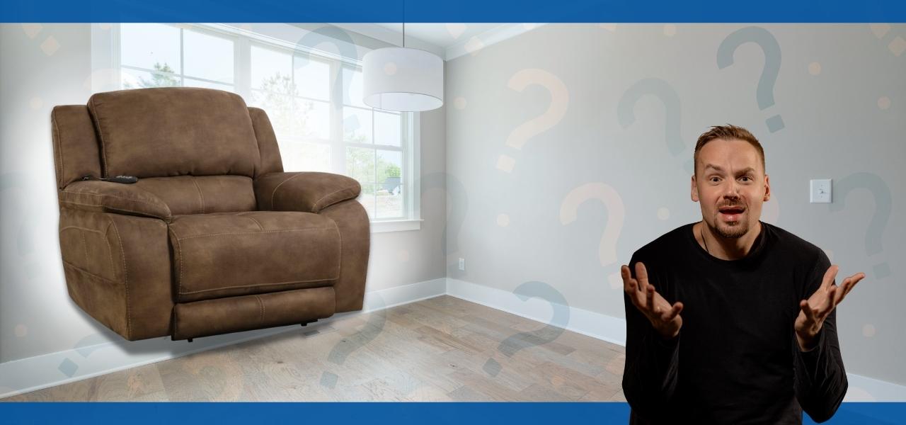A person gesturing beside a brown recliner in a room.