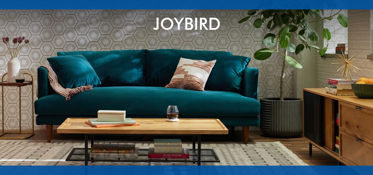 A stylish teal sofa by Joybird with a coffee table in a cozy living room.