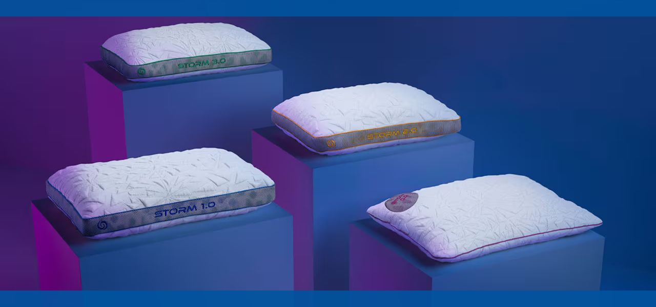 Four pillows displayed on blue pedestals against a colorful background.