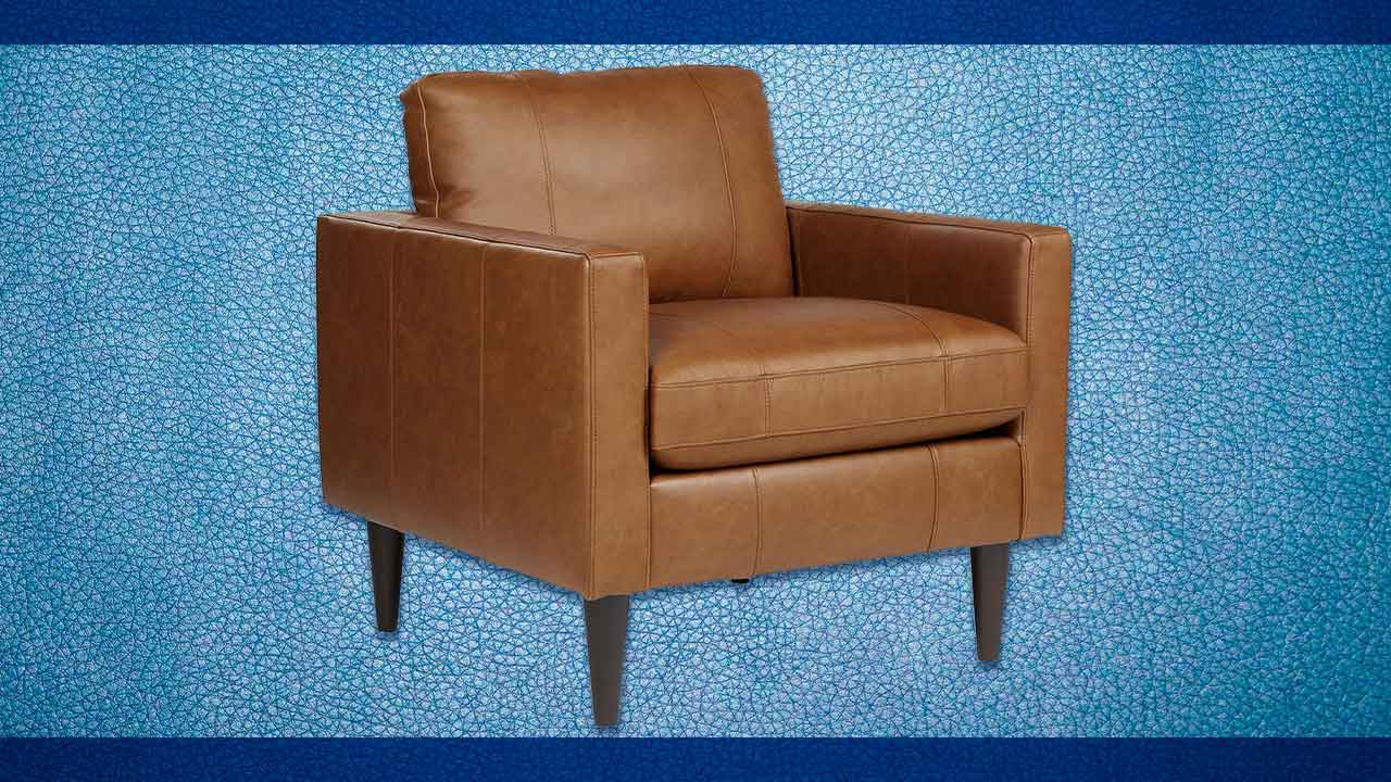 Close-up of fine-grained dark brown leather upholstery texture showing natural pebbled grain