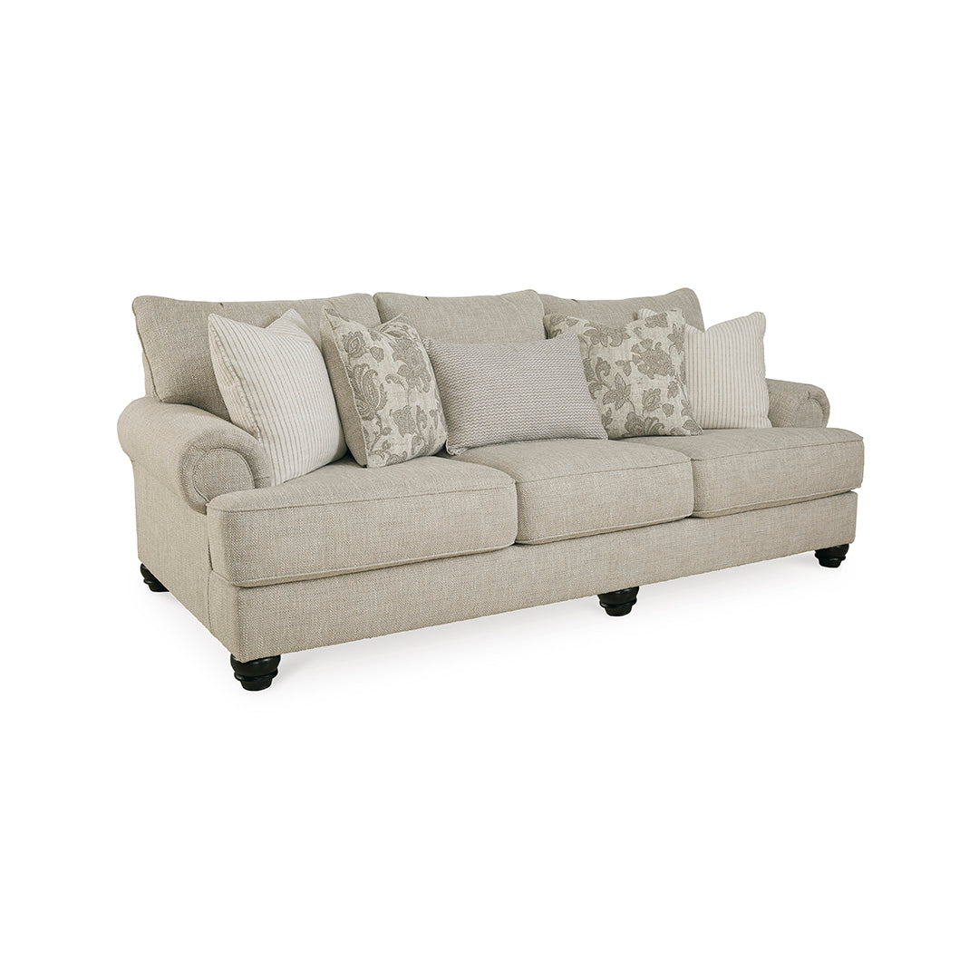 Beige sofa with patterned cushions on a white background