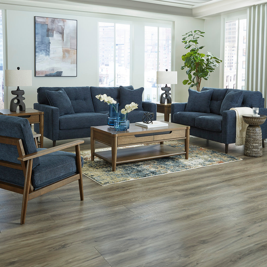 Full living room scene featuring the Bixler sofa by Ashley Furniture in blue upholstery