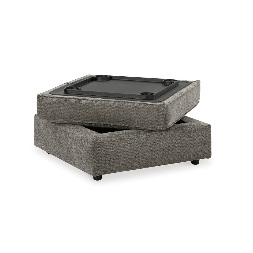 Gray ottoman with a black top surface on a white background