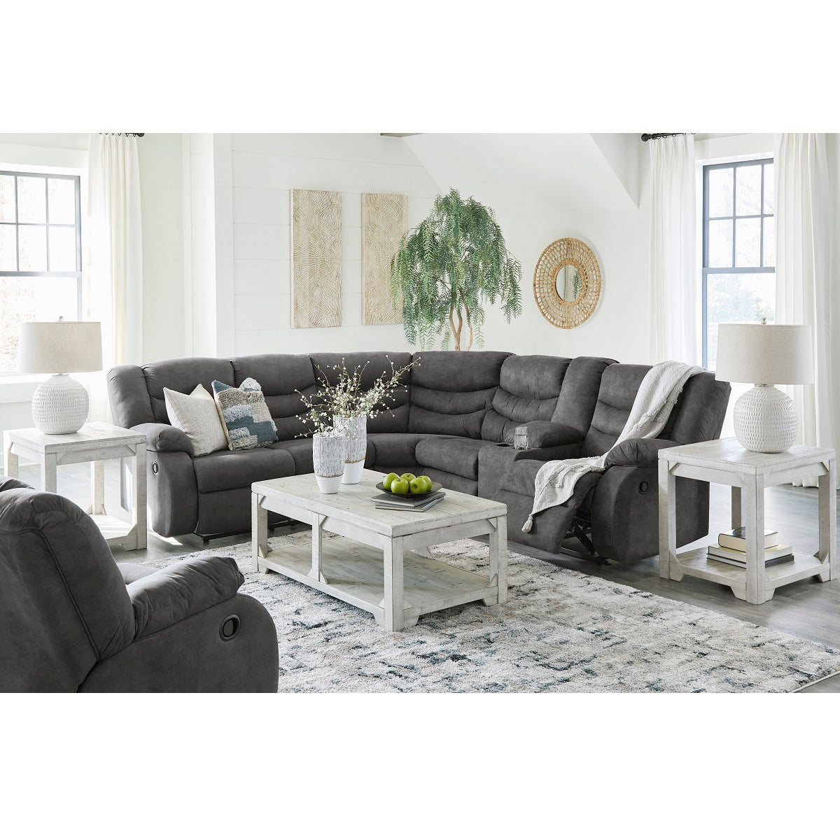 Partymate 2-Piece Manual Reclining Sectional by Ashley Furniture in Slate Gray. A modern and luxurious sectional featuring 6 spacious seats,  cup holders, and a storage console on the right side. Plush cushioning in the seats, arms, and backs for ultimate comfort. Slate gray faux leather upholstery is easy to maintain and clean.