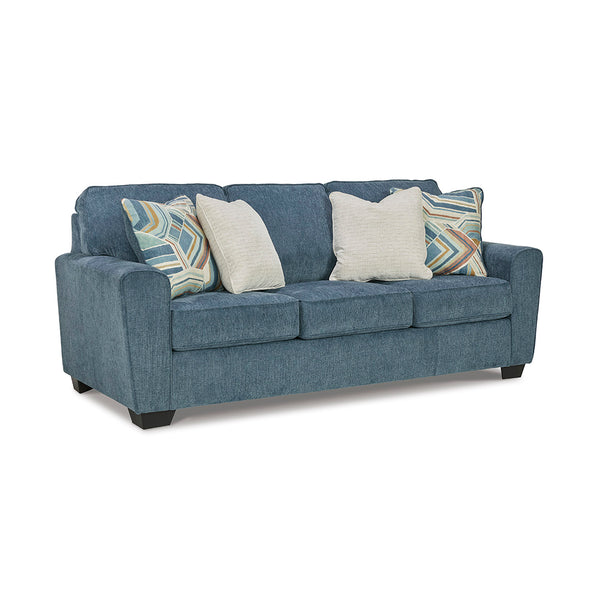Cashton Blue Sleeper Sofa by Ashley Furniture with decorative pillows on a white background