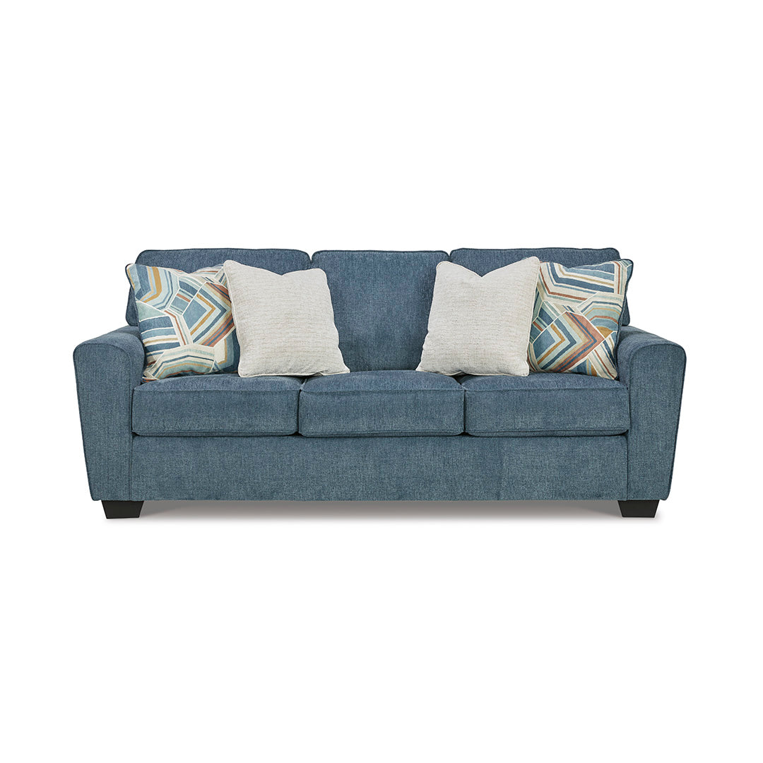 Cashton Blue Couch by Ashley Furniture with patterned and plain cushions on a white background