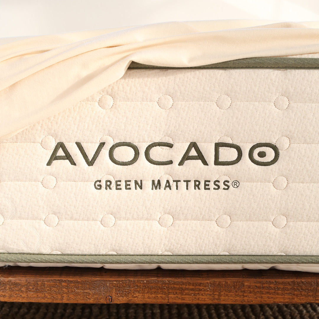 Avocado Pillowtop Green organic mattress in bedroom with natural lighting showing GOTS-certified organic cotton cover