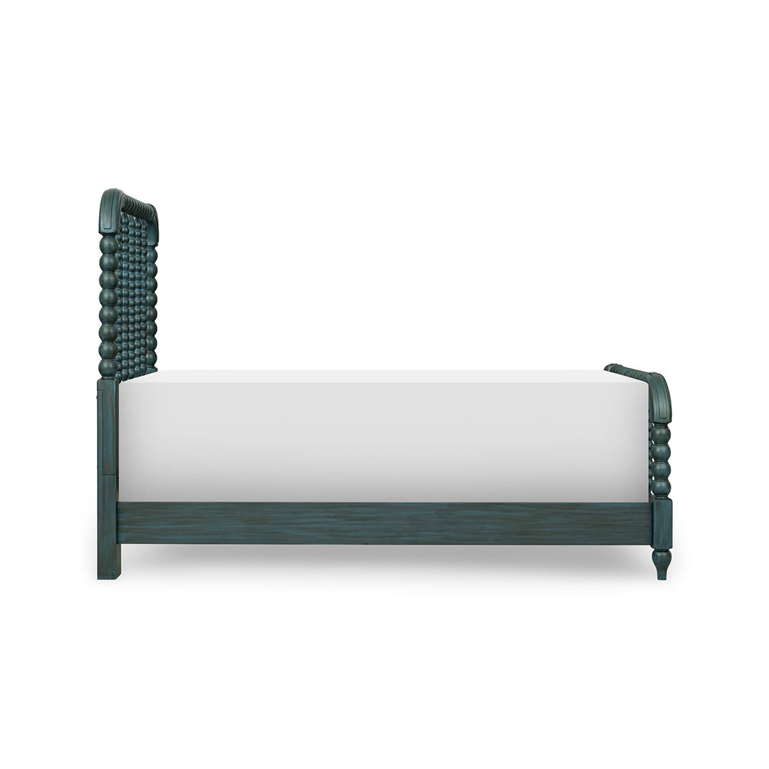 A dark teal wooden bed frame with a tufted headboard and turned legs, shown with a white mattress on a solid white background.