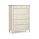 An off-white five-drawer chest of drawers with round knobs, turned legs, and decorative fluted side details.