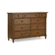 A rustic brown wooden dresser with eight drawers, featuring turned spindle-style side posts and round drawer knobs.