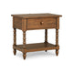 A rustic wooden nightstand with a single drawer, turned spindle legs, and a lower shelf.