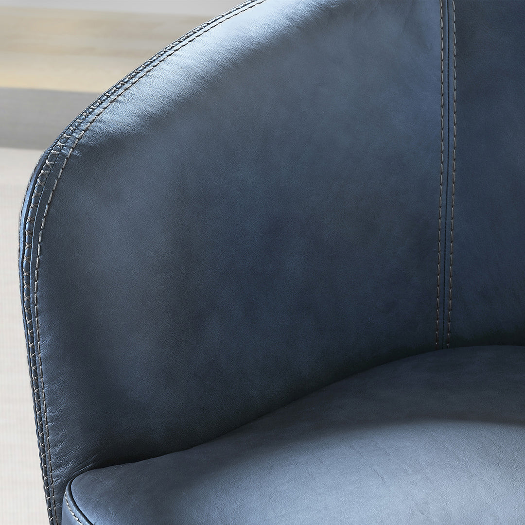 Close-up of a blue leather chair with visible stitching