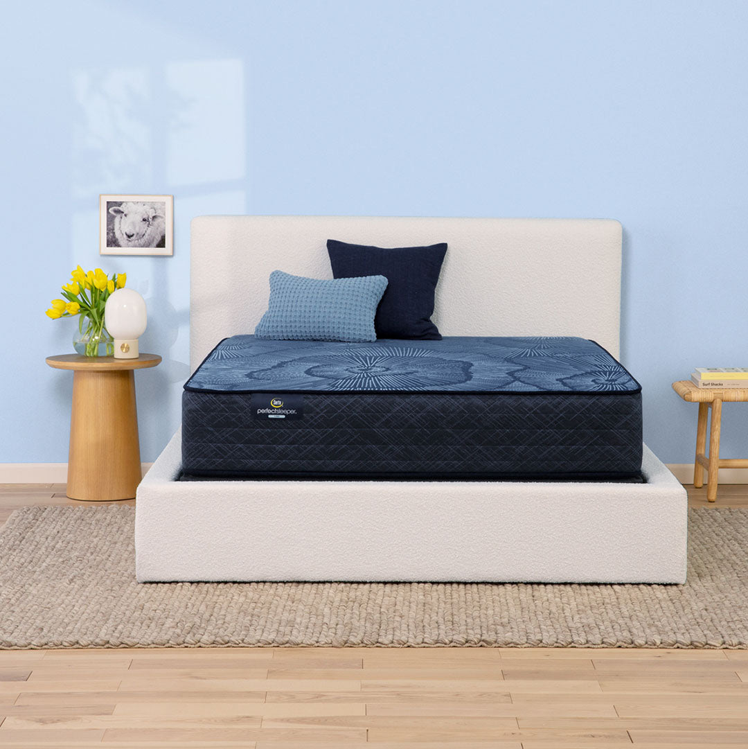 Delani Dreams Medium Perfect Sleeper mattress by Serta styled on a bed