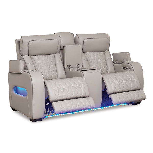 Boyington power reclining loveseat with open console and arm compartments by Ashley Furniture
