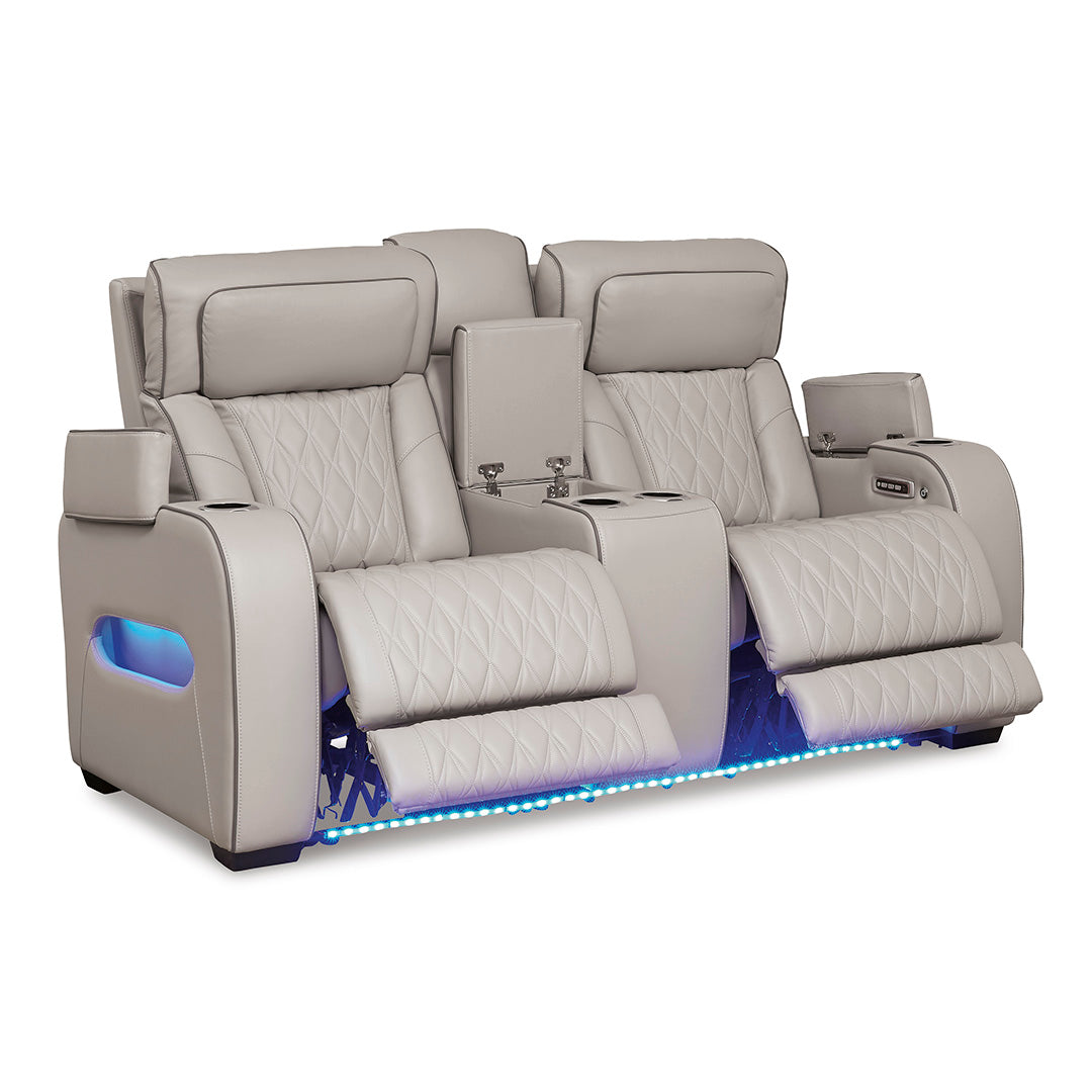 Boyington power reclining loveseat with open console and arm compartments by Ashley Furniture