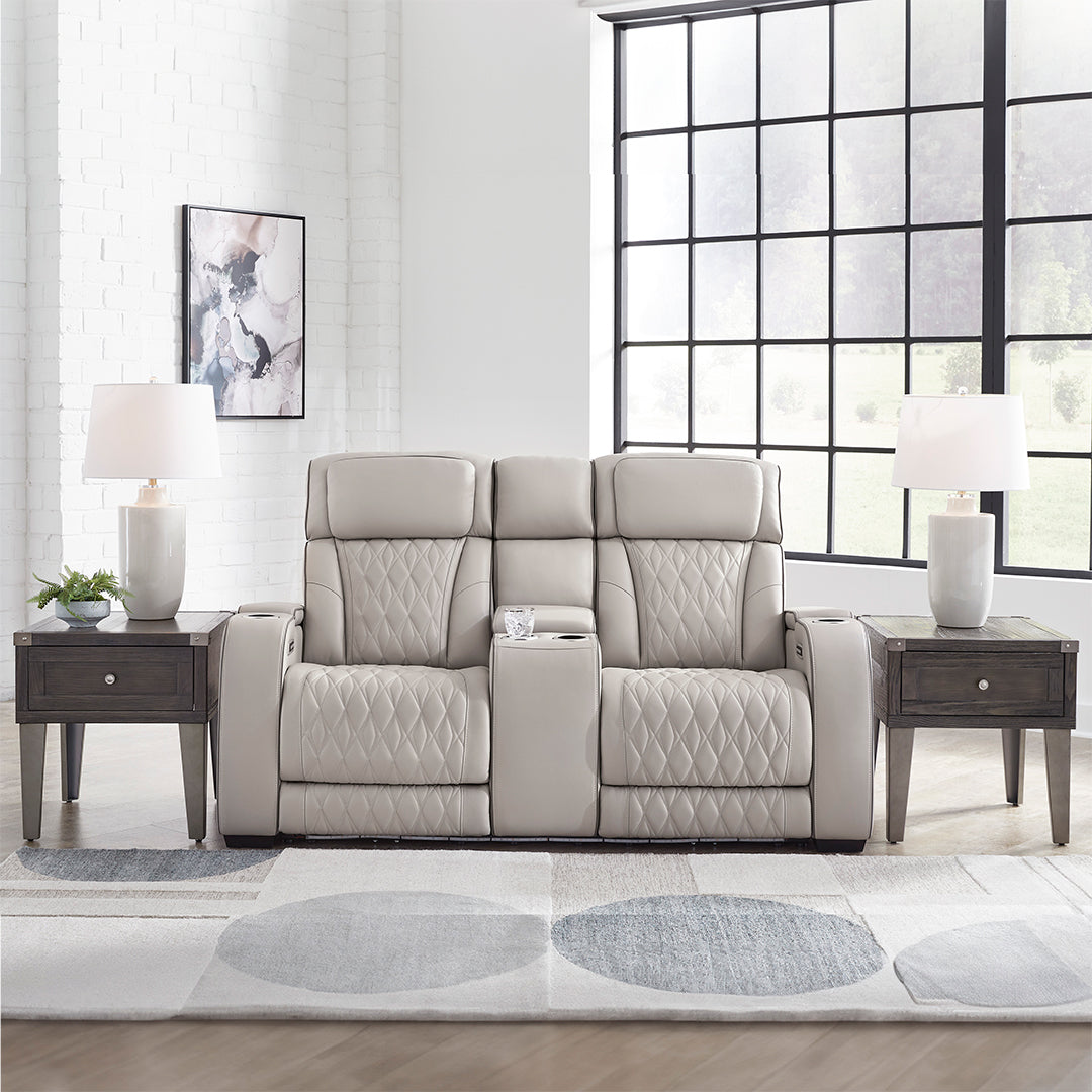 Boyington power reclining loveseat with console by Ashley Furniture shown front-facing in a living room