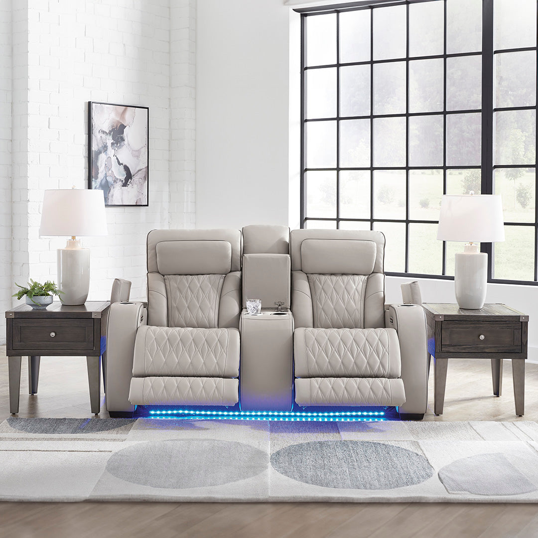Boyington power reclining loveseat with console by Ashley Furniture styled in a living room