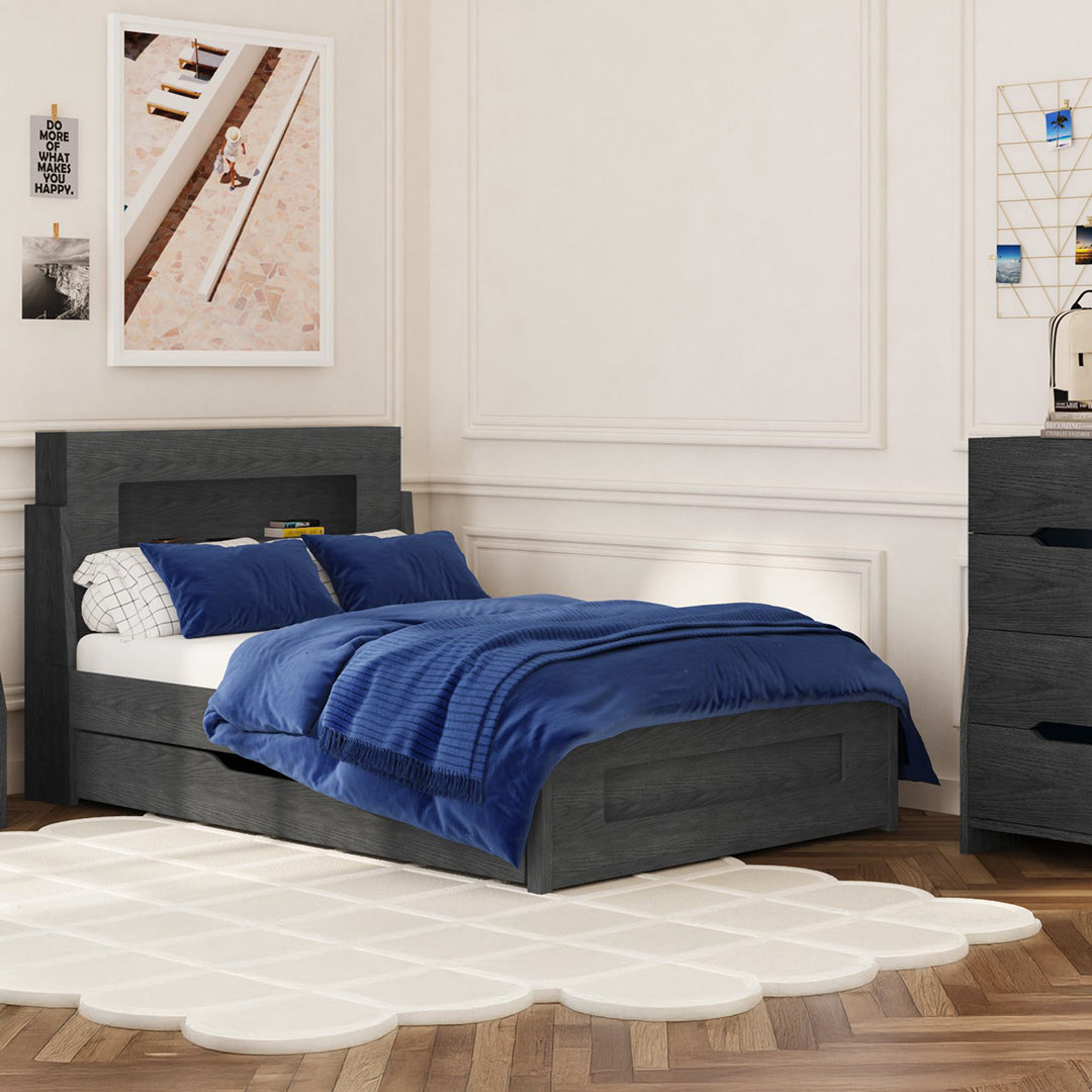 Bedroom with a bed featuring blue bedding and pillows, wooden floor, and wall decorations.