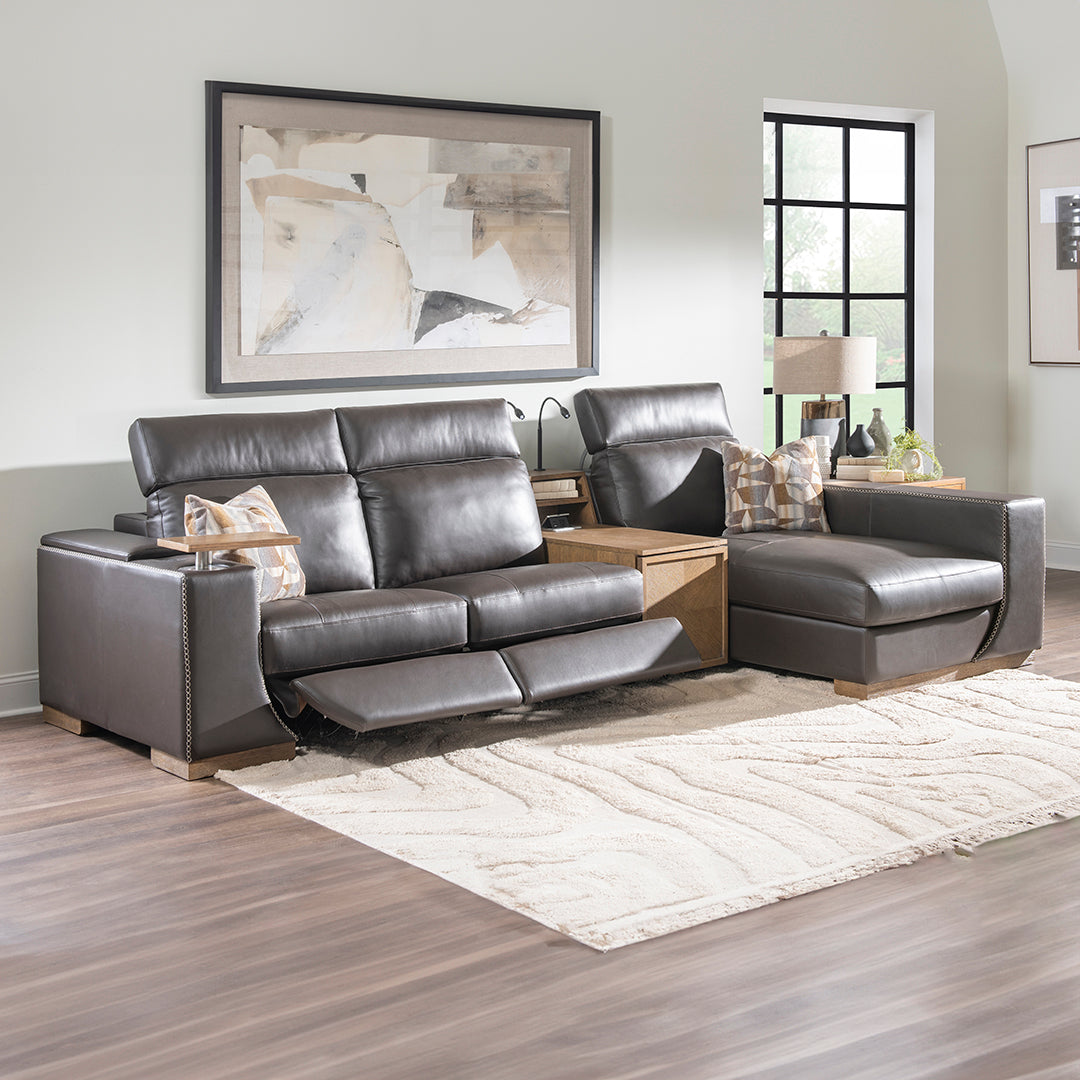 Modern leather power reclining sectional sofa with footrests extended in living room setting