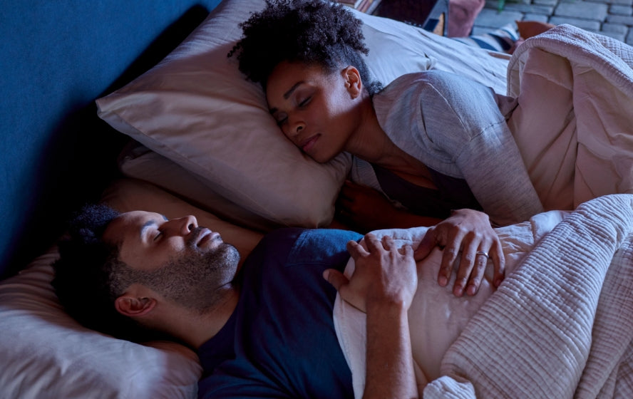 Couple sleeping comfortably on a cooling mattress with temperature regulation technology