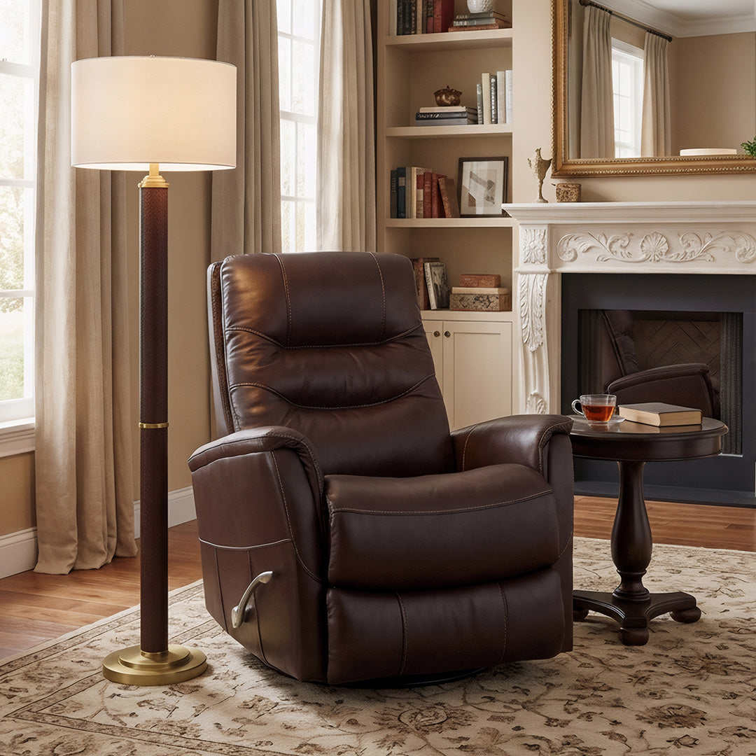 Warm living room with a brown top-grain leather recliner centered on an area rug beside a fireplace