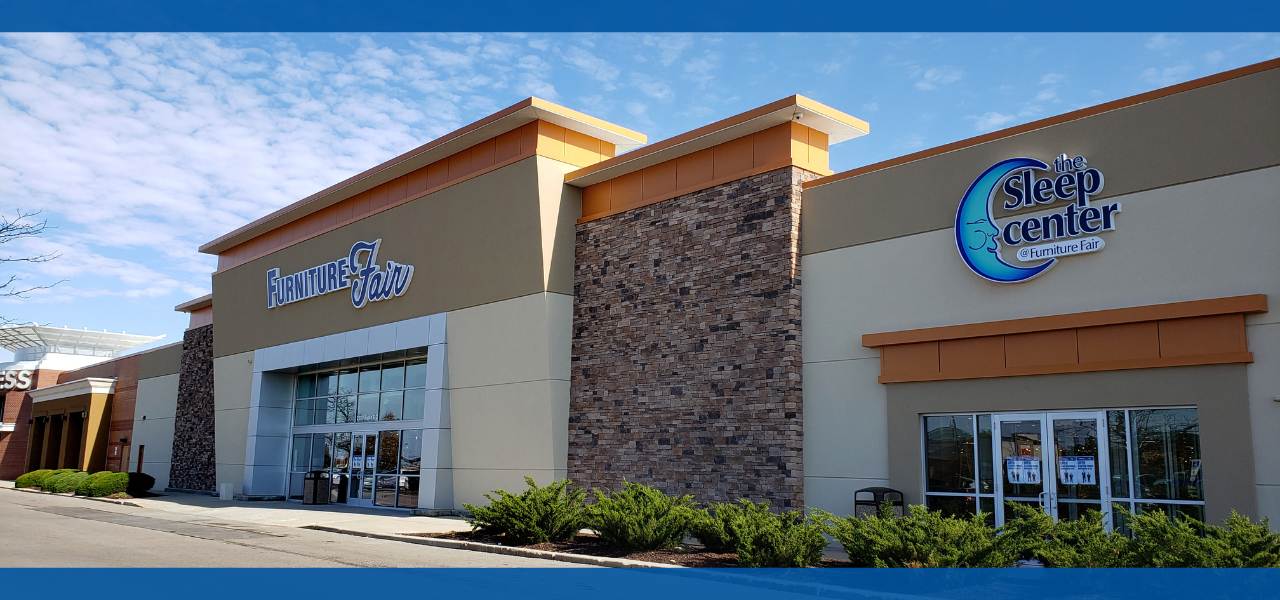Exterior view of a retail store with clear blue sky.