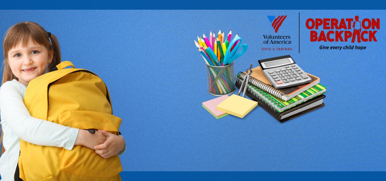 Child hugging a yellow backpack with school supplies on a blue background.