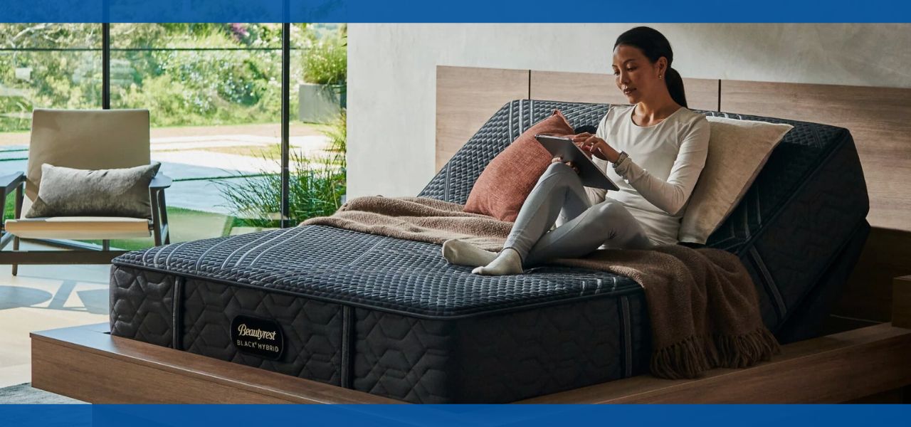 Person reading on an adjustable bed in a modern bedroom setting.