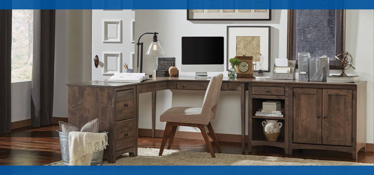 Home office setup with a wooden desk, chair, and computer.