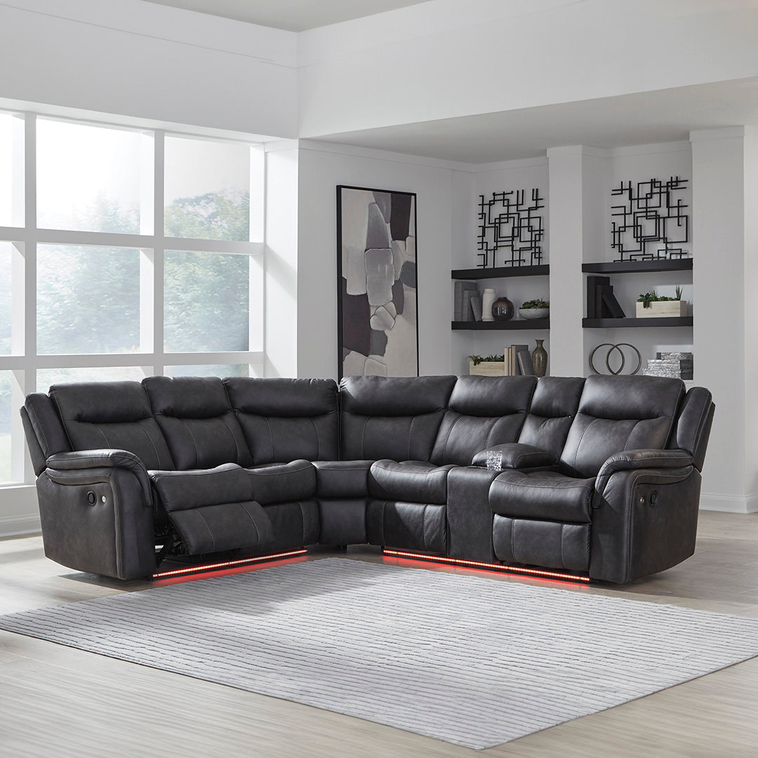 Black leather sectional sofa in a modern living room with large windows.