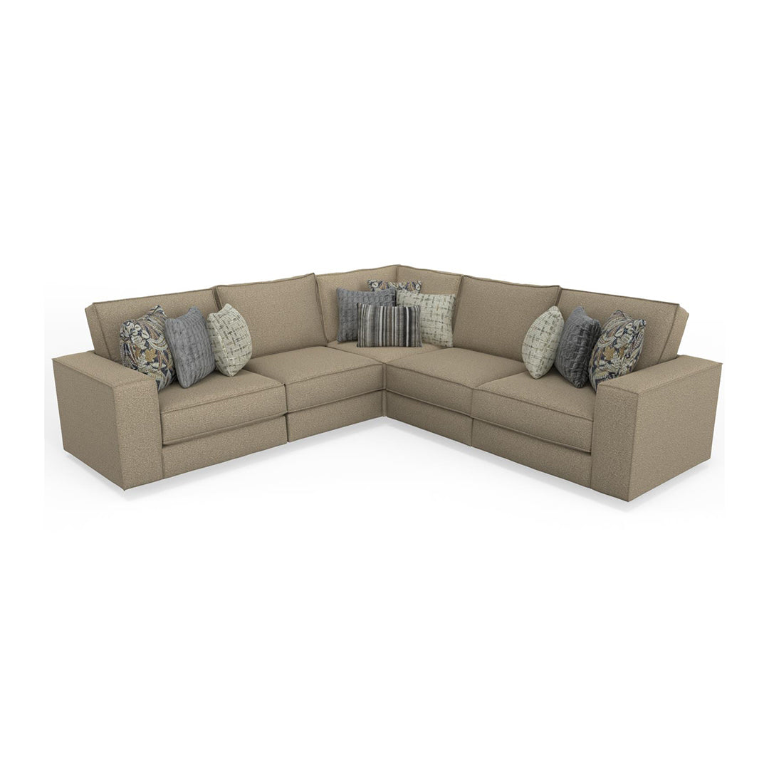 Beige sectional sofa with patterned cushions on a white background