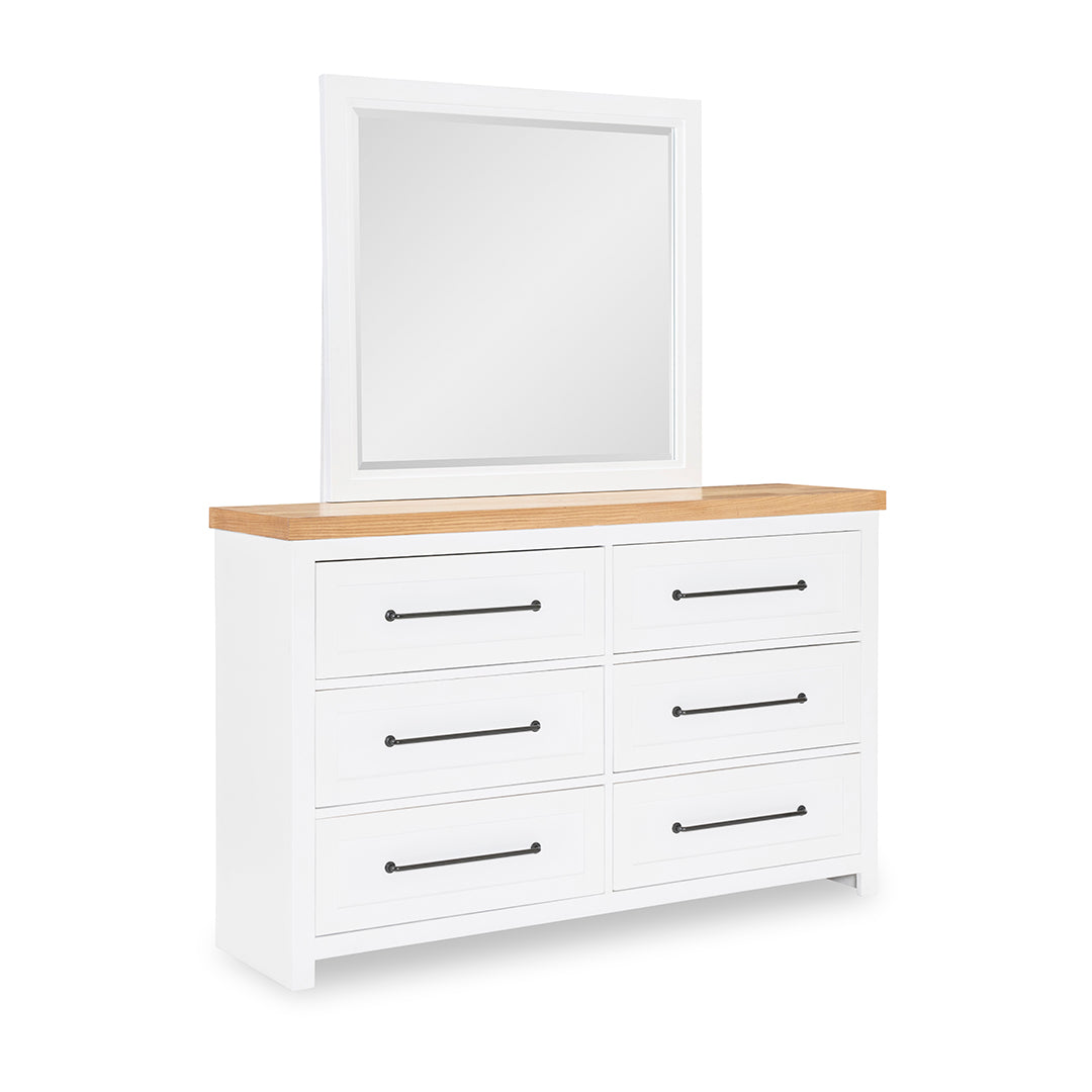 White dresser with wooden top and mirror on a white background
