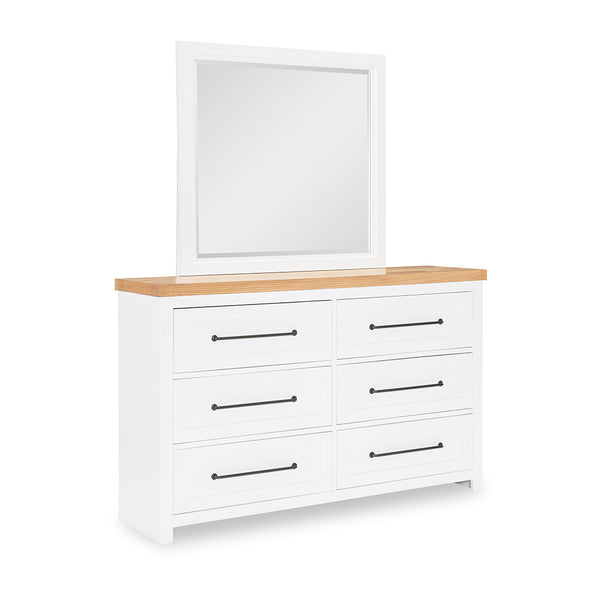 White dresser with wooden top and mirror on a white background