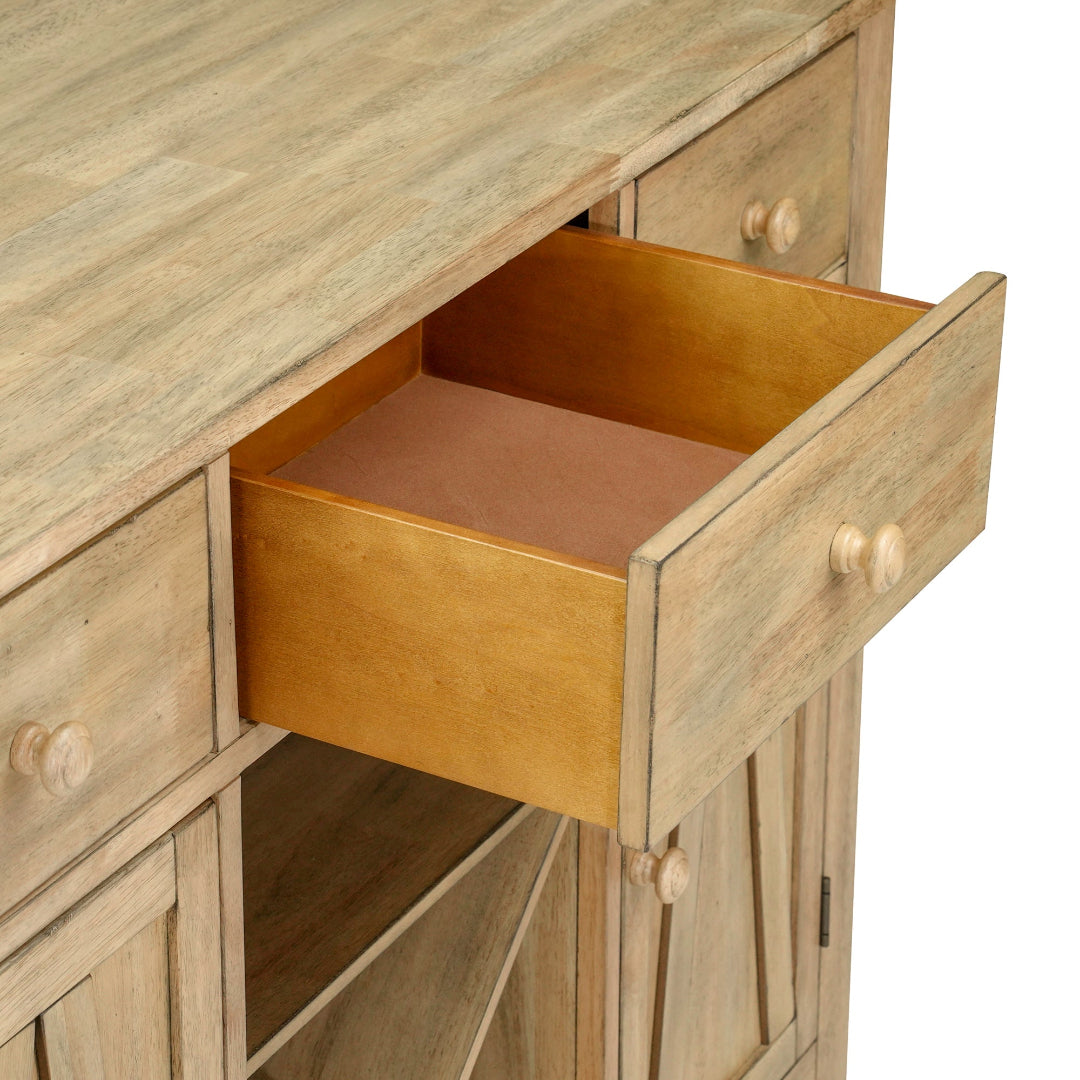 Close-up of a rustic light brown wooden cabinet with one drawer pulled open, showing a warm honey-toned interior and round wooden knobs against a white background.