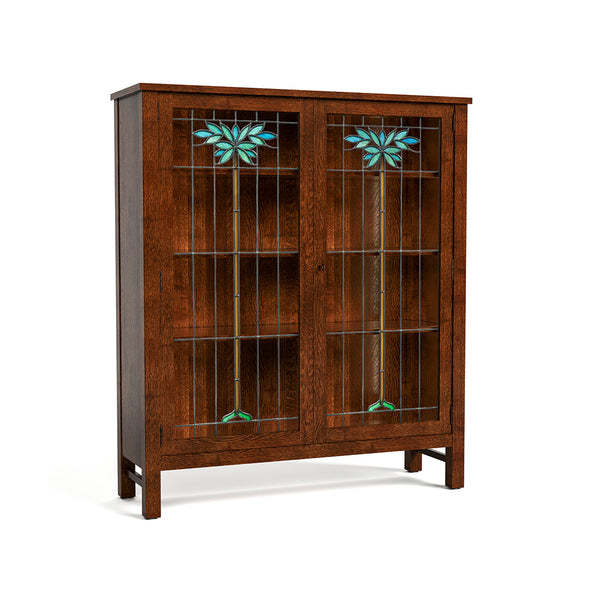 A mid-century modern wooden cabinet with two glass-front doors featuring turquoise and green stained glass floral motifs, set against a plain white background.