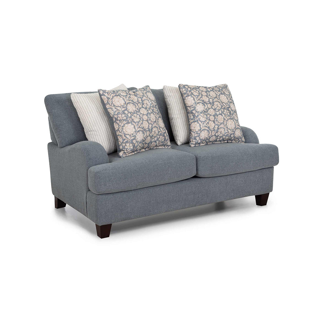 Gray sofa with patterned and solid cushions on a white background