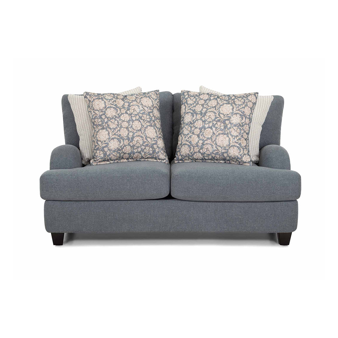 Gray sofa with floral-patterned cushions on a white background