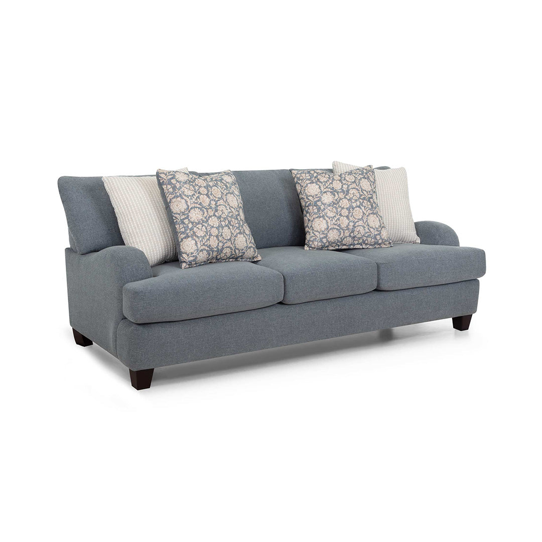 Gray sofa with patterned and solid cushions on a white background