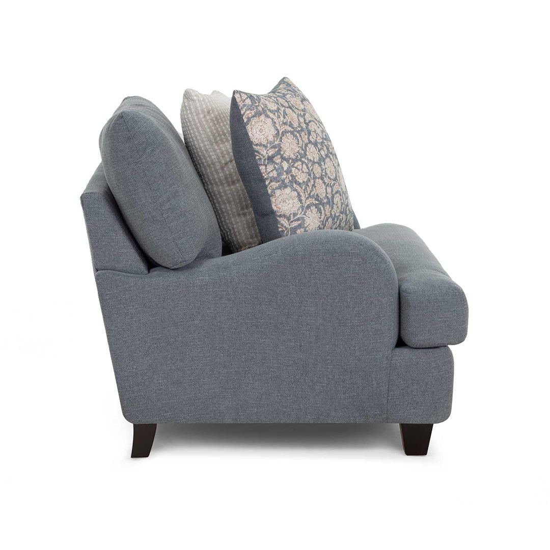Gray armchair with decorative pillows on a white background