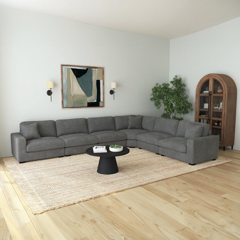 Large 6-piece modular sectional seating arrangement positioned over an expansive living room area rug