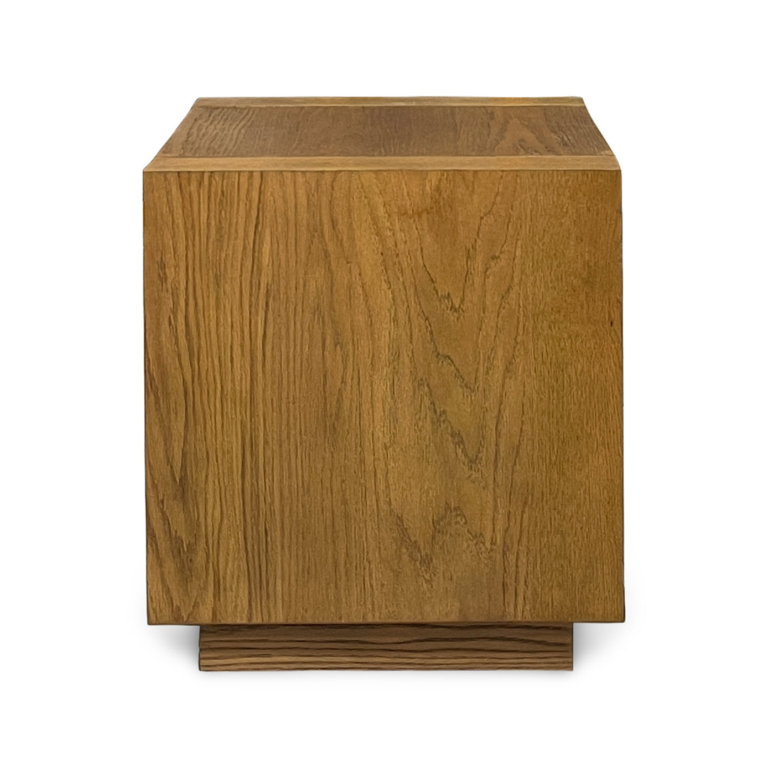 A modern square wooden side table or end table with a rich medium-brown wood grain finish and a low tiered base, shown on a plain white background.