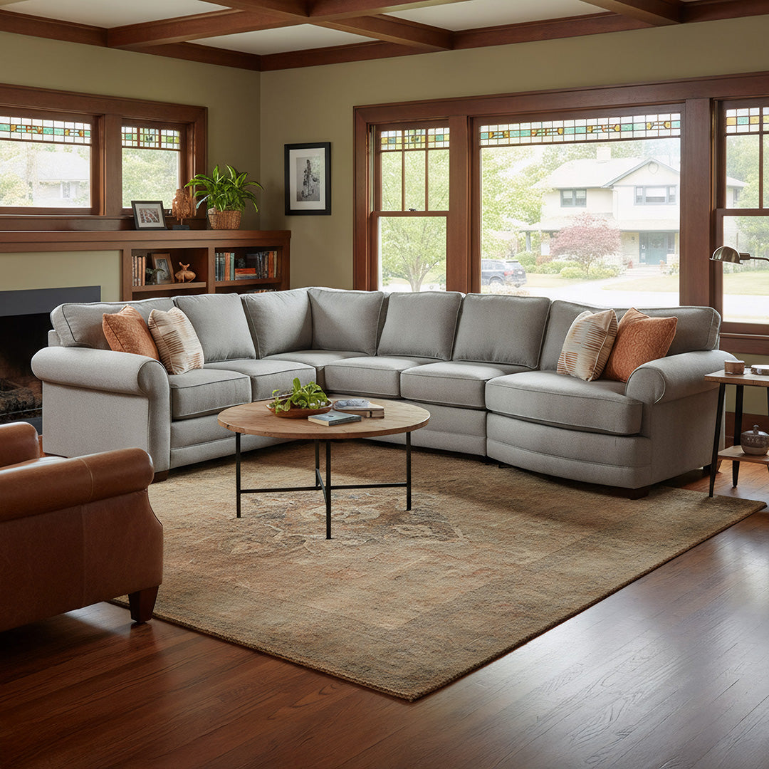 Living room with a sectional sofa, coffee table, and decorative items.