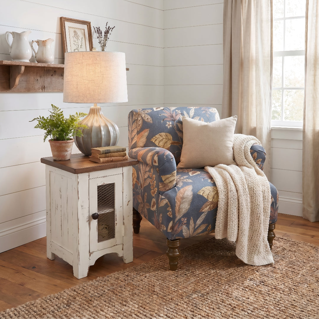 Cozy living room corner with armchair, side table, and decorative items.