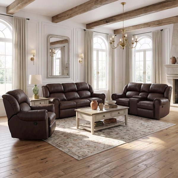 A staged living room showing a dark brown leather sofa, matching loveseat, and a dark brown leather recliner arranged around a white coffee table on a patterned area rug. The room features white walls, arched windows with beige curtains, a fireplace, and exposed wooden ceiling beams.