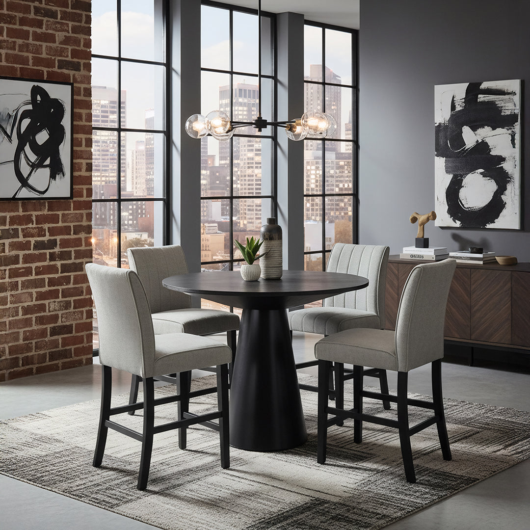 Modern dining room with a round black table and gray chairs, large windows, and abstract art on the walls.