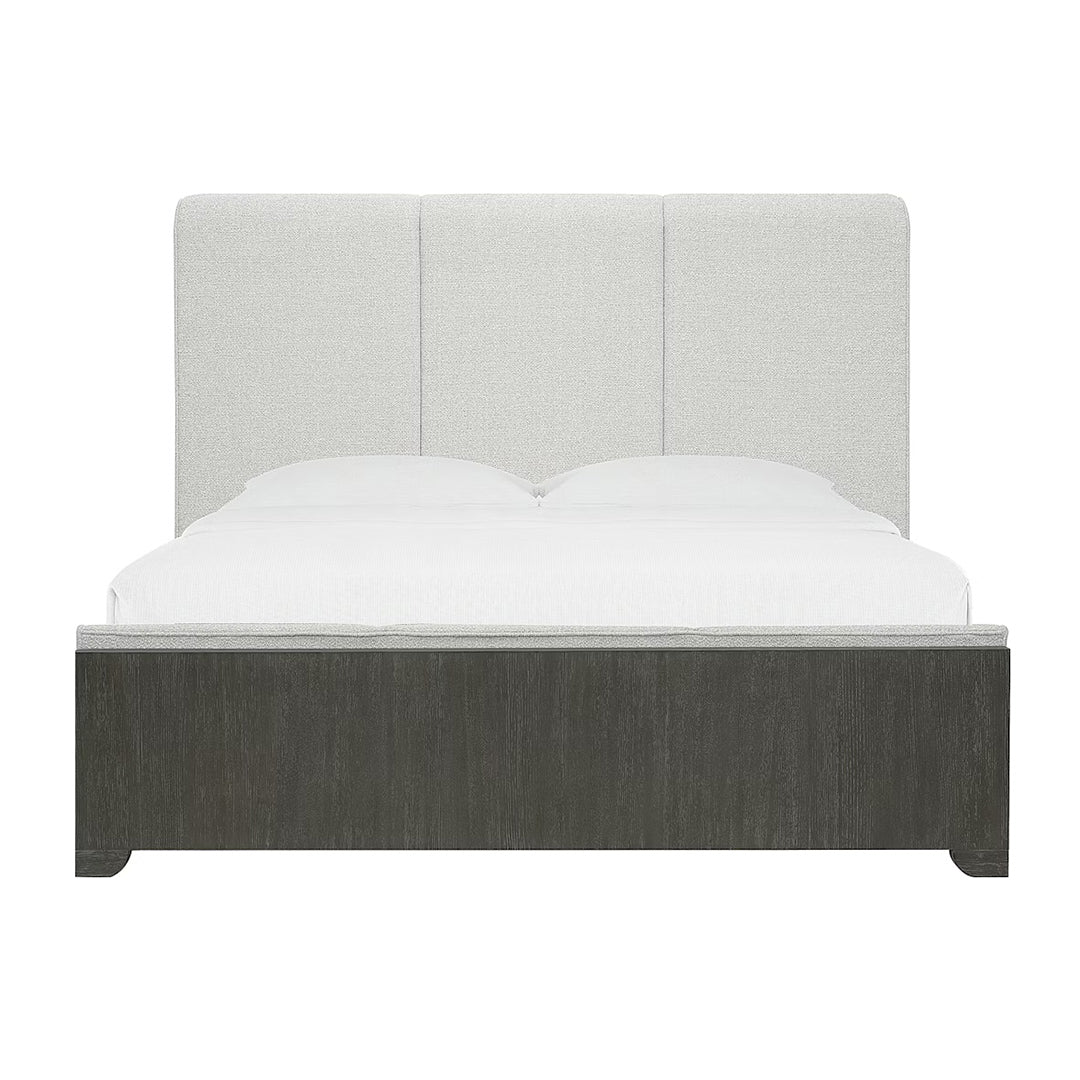 King bed with gray upholstered headboard and dark wooden frame.