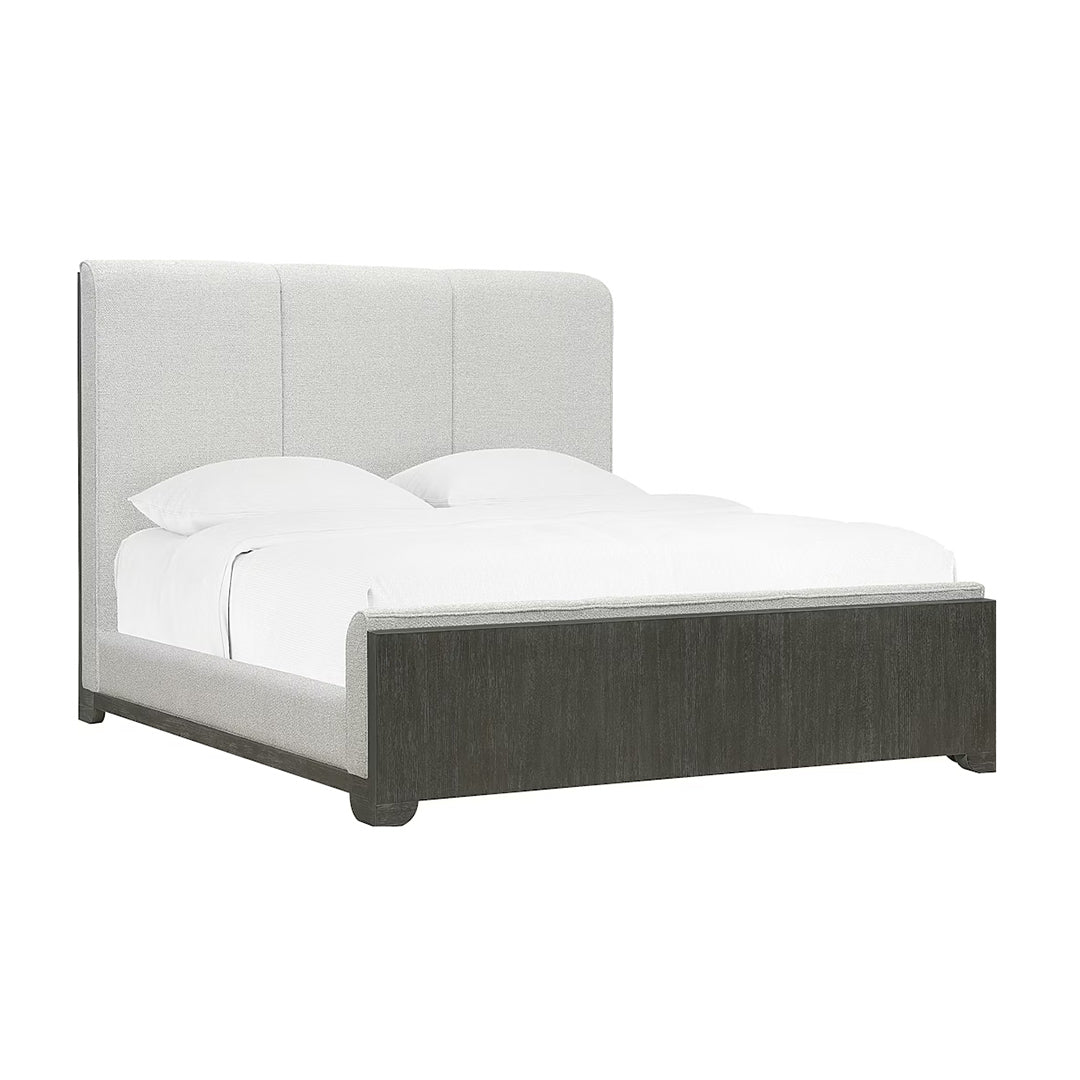 King bed with gray upholstered headboard and dark wooden frame.