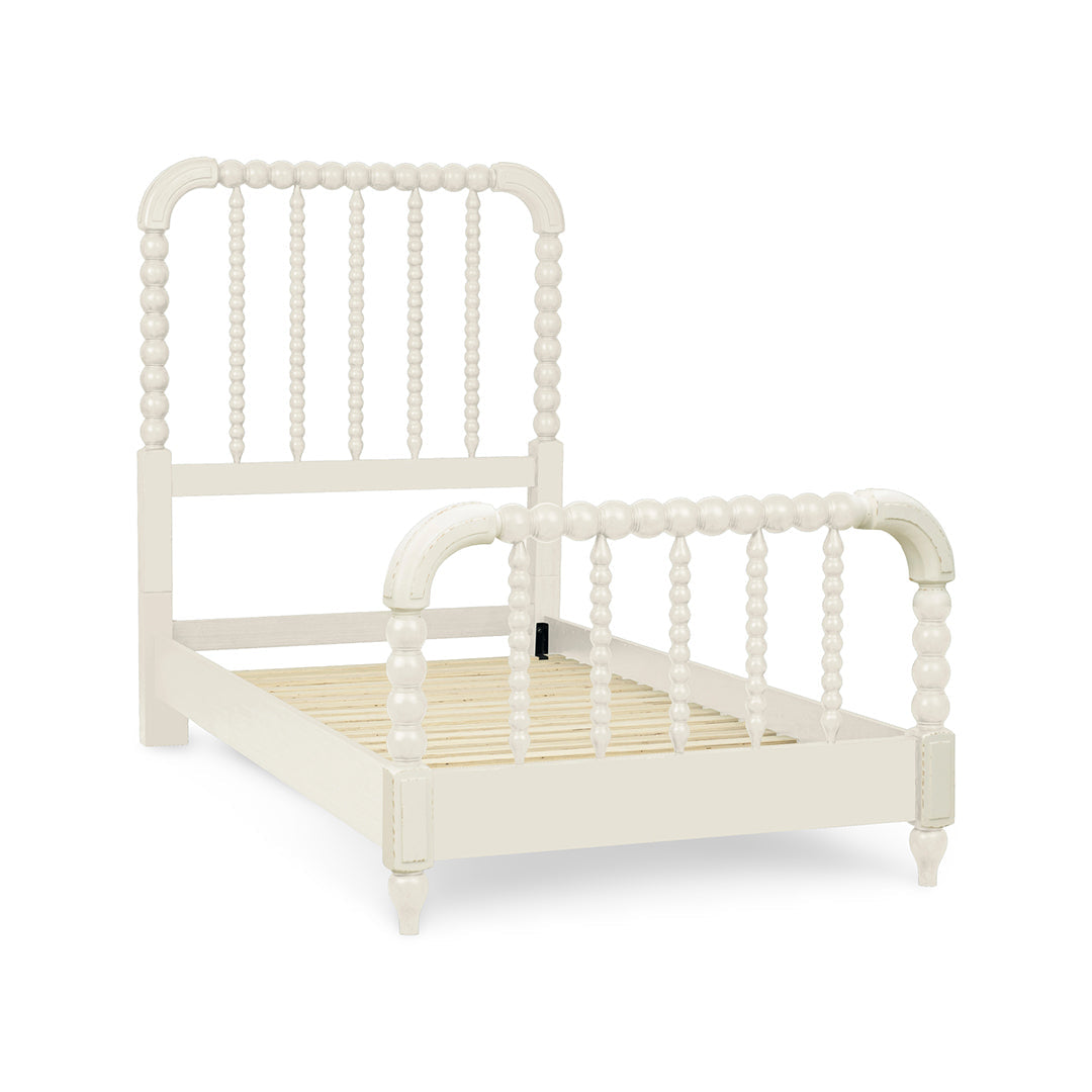 A single bed frame with a spindle headboard and footboard in an off-white finish.