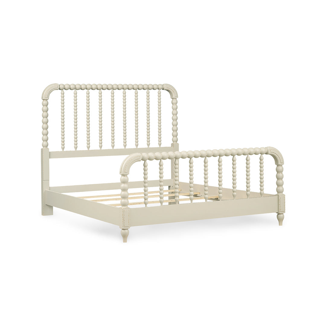 A single bed frame with a spindle headboard and footboard in a light cream or off-white finish.