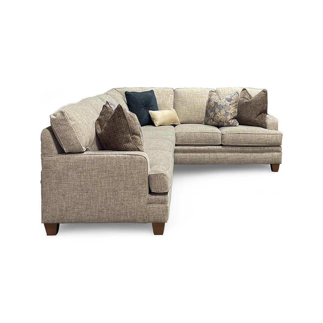 Gray sectional sofa with decorative pillows on a white background